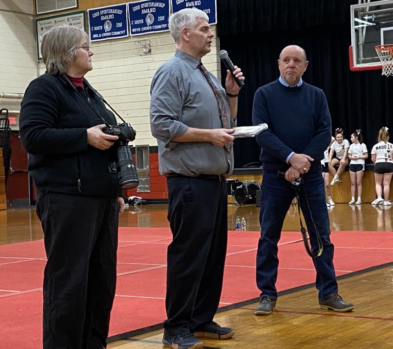 Athletic director/assistant principal Warren CossetteWarren Cossette, center, recognizes Paula Roberts of Lincoln County News and, far right, Wiscasset Newspaper news contributor Phil Di Vece with the Spirit of the Wiscasset Wolverines Award at Wiscasset Middle High School’s Winter Carnival Feb. 14. Courtesy of Brion Controvillas