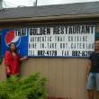 Wiscasset's new owner Odeth Busque, left, and manager Praphan Kaewthong stand by their new sign while preparing for their grand opening on August 28.