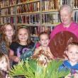 Jesse, Violet, Jasmine, Alexa and Braden stand with Georgie Thompson, who is holding a cast of a dinosaur footprint. Courtesy of Wiscasset Public Library