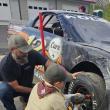 Peter Kolbe and Arrow of Light Scout Jereimiah Raposa change a tire. Courtesy photo 