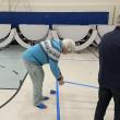 Elizabeth Sylvester puts down blue tape for pickleball at DES. Peter Walsh photo