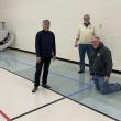 From left, Susan Hartford, Kipp Bacon and Randy Finamore (kneeling) help with a pickleball unit at Dresden Elementary School. Peter Walsh photo 