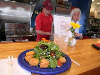 Friday's special was mesclun salad with scallops. Cook Mike Welsh and Manager and Chef Catherine Day prepare meals on July 13. DIANE RANDLETT/Boothbay Register DIANE RANDLETT / Boothbay Register mesclun salad with scallops Oliver's Cozy Harbor wharf