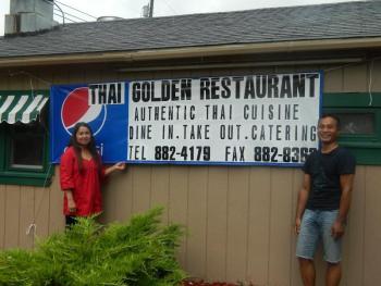 Wiscasset's new owner Odeth Busque, left, and manager Praphan Kaewthong stand by their new sign while preparing for their grand opening on August 28.