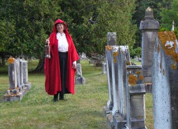 Sally Lobkowicz, director of Red Cloak Haunted History Tours, explores a cemetery. The popular walking tours, which have included five Mid Coast Maine towns for the past seven years, is opening a new option for their guests Red Cloak Cemetery Tours.