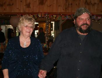 A surprised Ann Quinnam Gagnon Sparks enters 29 Pine Cove (former Tuxedo Junction) with her son, Joey Gagnon, to be greeted by over 100 guests ready to celebrate her 80th birthday.