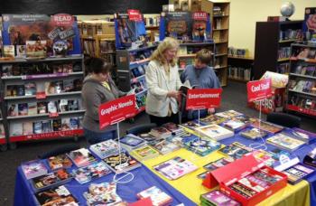 Margie Hodgdon, Molly Carlson and Joshua Golden check out the book selection at the Wiscasset Middle School’s book fair. Courtesy of Wiscasset Middle School 