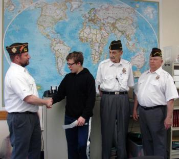 Bath View Post 7738 Junior Vice Cmdr. Kenneth Lambert, left, hands David Marcus an $800 check on April 26. Post Cmdr. Arthur Edwards and Quartermaster Tom Rainey look on. SUSAN JOHNS/Wiscasset Newspaper