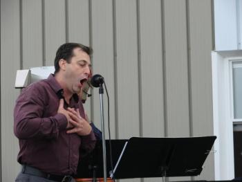 Dennis St. Pierre sings for area businesspeople at Wiscasset Municipal Airport on June 13. St. Pierre is producer of the August 6 “Wings Over Wiscasset” event. Admission is free. SUSAN JOHNS/Wiscasset Newspaper