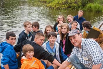 Boat Shop Manager Kurt Spiridakis and middle school students launch two skiffs at a ceremony on Nequasset Brook in Woolwich June 13. Courtesy of Kurt Spiridakis and the Maine Maritime Museum Boat Shop