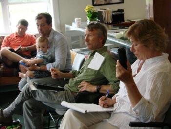 Four committee members and a baby: From left, Wiscasset Parks & Recreation Department Director Todd Souza, “Wings Over Wiscasset” producer Dennis St. Pierre with son Oliver Gadebirk-St. Pierre, age 1, Boothbay Railway Village Board of Directors President Stephen Williams and Wiscasset Municipal Airport employee Kim Powers meet with fellow “WOW” committee members at the airport July 8. SUSAN JOHNS/Wiscasset Newspaper