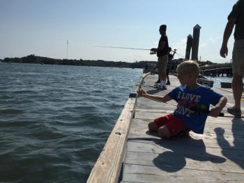 Jim and Jessette Asdot's nephew Jace fishes along the Wiscasset waterfront Aug. 5. SUSAN JOHNS/Wiscasset Newspaper