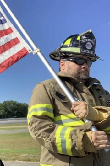 Mike Warren honors the Farmington firefighters while he takes part in the fundraiser at Wiscasset Speedway Sept. 21 for Dean Snell Cancer Foundation. Courtesy of Mikayla Warren