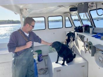 Fishing buddies: Terry Ashton, Dace and Puck. SUSAN JOHNS/Wiscasset Newspaper