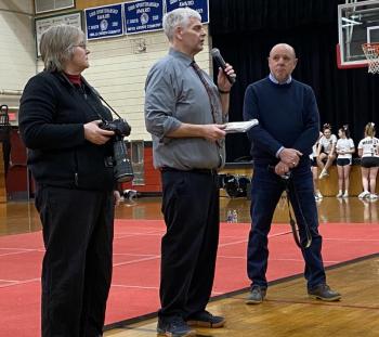 Athletic director/assistant principal Warren CossetteWarren Cossette, center, recognizes Paula Roberts of Lincoln County News and, far right, Wiscasset Newspaper news contributor Phil Di Vece with the Spirit of the Wiscasset Wolverines Award at Wiscasset Middle High School’s Winter Carnival Feb. 14. Courtesy of Brion Controvillas