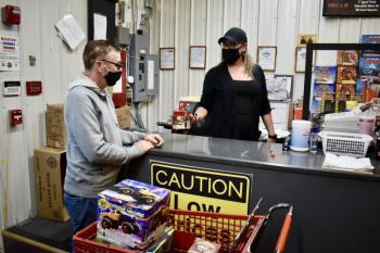 Joel Verney of Alna stocks up on fireworks at Big Al’s Fireworks Outlet. Also shown is employee Cortney Harris. PHIL DI VECE/Wiscasset Newspaper