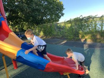 Corben Jones, 6, left, and brother Paxton, 4, use the slide during Wiscasset Elementary School’s outdoor open house Sept. 16. SUSAN JOHNS/Wiscasset Newspaper