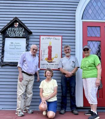 From left, Fundraising Committee Chair Richard Malaby and some of the committee’s members, Sharman Ballantine, Jon Young and Gretchen Burleigh-Johnson. On the building is a symbolic burning candle created by Mat O'Donnell and Seaver Leslie to illustrate funds raised. Marcie Patton photo