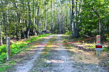 Peter Mullin's property in Boothbay with a chain across the driveway and a sign that reads "not for sale."