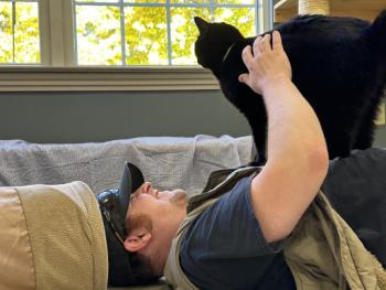 Eric Hutchinson helping to socialize a cat at Mid Coast Humane in Brunswick. ECB photo