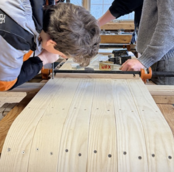 Great Salt Bay students put finishing touches on a white ash toboggan. Courtesy photo