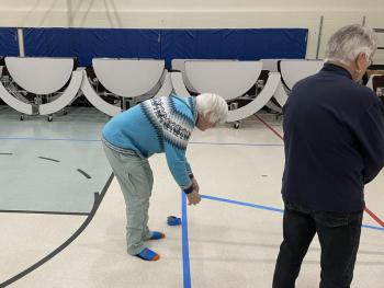 Elizabeth Sylvester puts down blue tape for pickleball at DES. Peter Walsh photo