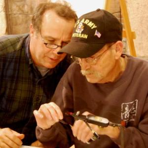 Veterans Camp volunteer Dr. Sean Moran, left, gives tips to a Vietnam veteran during the fly-tying workshop at camp. Courtesy of Joe Tatem