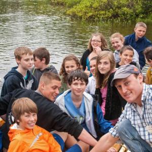 Boat Shop Manager Kurt Spiridakis and middle school students launch two skiffs at a ceremony on Nequasset Brook in Woolwich June 13. Courtesy of Kurt Spiridakis and the Maine Maritime Museum Boat Shop