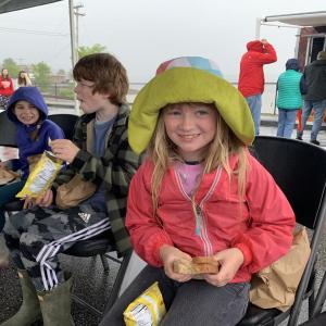 Edgecomb’s Olive Emerson, 8, looks up from her turkey and cheese sandwich at Wormfest in Wiscasset May 31. Also enjoying lunch under the tent were Boothbay’s Arbor Lewis, 8, and Austin Lewis, 10. SUSAN JOHNS/Wiscasset Newspaper Wormfest