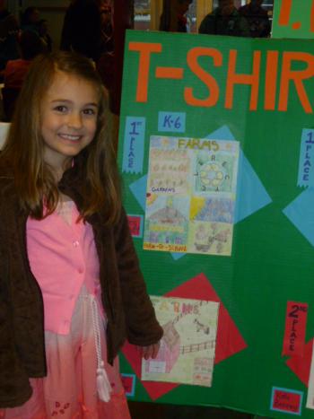 Mara Abbott, daughter of Jason and Alexa Abbott of Westport Island, is all smiles as she is recognized for creating the best T-shirt design in the Focus on Agriculture in Rural Maine Schools’ contest. Courtesy of Alexa Abbott